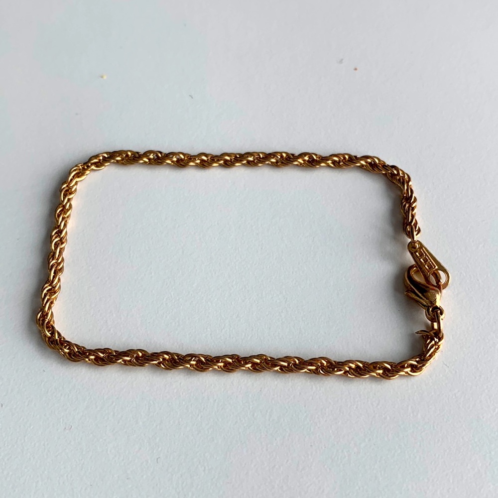 Gold toned metal bracelet marked